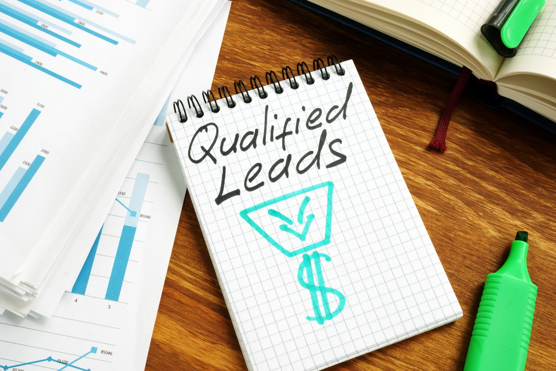 A notebook with ‘Qualified Leads’ written on it, symbolizing Prime Virtual Solutions’ lead generation services designed to increase qualified leads for realtors and loan officers in Las Vegas, NV.