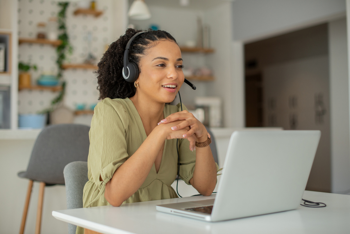 A professional woman with a headset engaging in a video call, illustrating Prime Virtual Solutions’ cold calling services aimed at generating leads for realtors and loan officers in Las Vegas, NV.